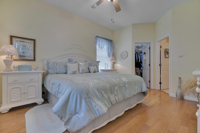 23 Chestnut Ln Unit 23, Wells, ME 04090 - bedroom with light wood-type flooring, a walk in closet, a closet, and a ceiling fan