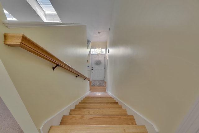 23 Chestnut Ln Unit 23, Wells, ME 04090 - staircase with a skylight, wood finished floors, and a chandelier