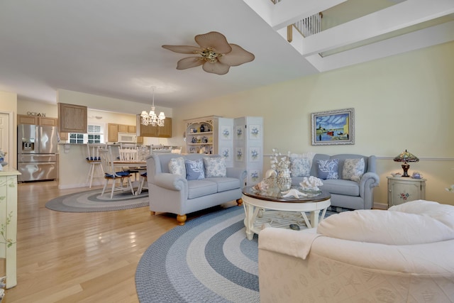 23 Chestnut Ln Unit 23, Wells, ME 04090 - living area with a chandelier, ceiling fan, and light wood-type flooring