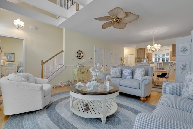 23 Chestnut Ln Unit 23, Wells, ME 04090 - living room featuring a chandelier, stairs, light wood-style floors, and a ceiling fan