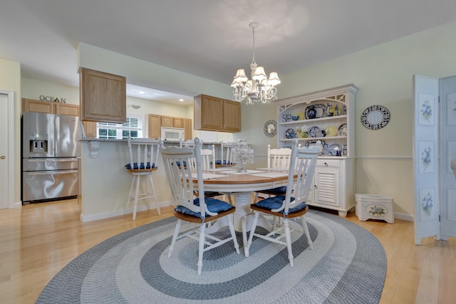 23 Chestnut Ln Unit 23, Wells, ME 04090 - dining room featuring a chandelier and light wood-style floors