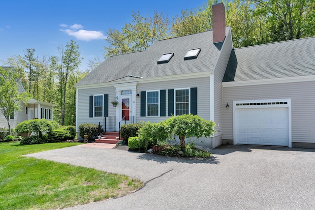 23 Chestnut Ln Unit 23, Wells, ME 04090 - new england style home featuring an attached garage, asphalt driveway, a shingled roof, a front yard, and a chimney