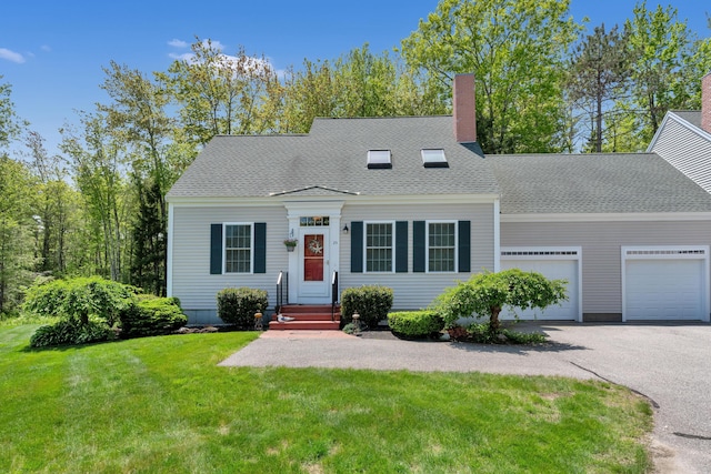 23 Chestnut Ln Unit 23, Wells, ME 04090 - cape cod home featuring a garage, a front lawn, driveway, roof with shingles, and a chimney