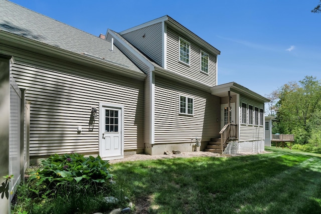 23 Chestnut Ln Unit 23, Wells, ME 04090 - back of property with a lawn and roof with shingles