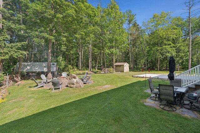 7 Dakota Ln, Dresden, ME 04342 - view of grassy yard with an outdoor fire pit and a storage shed