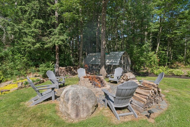 7 Dakota Ln, Dresden, ME 04342 - view of grassy yard with a fire pit and a storage unit