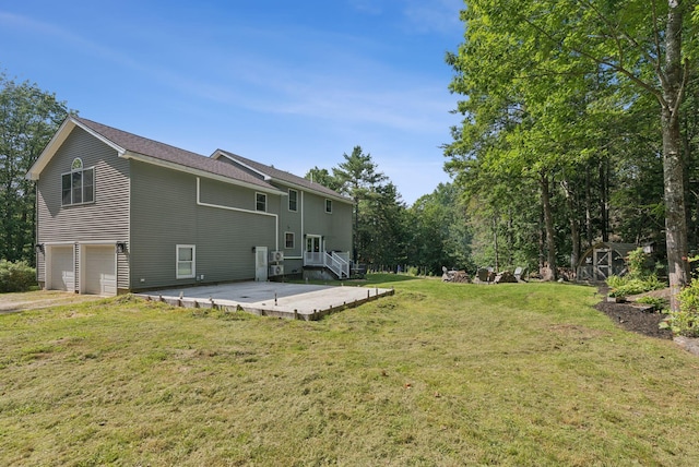 7 Dakota Ln, Dresden, ME 04342 - rear view of property with a patio area, a garage, and a lawn