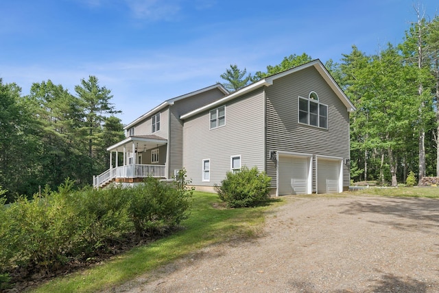 7 Dakota Ln, Dresden, ME 04342 - view of property exterior featuring driveway, a garage, and covered porch
