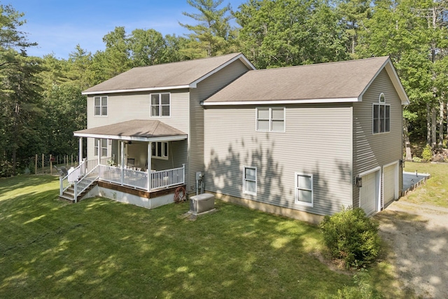 7 Dakota Ln, Dresden, ME 04342 - rear view of property featuring a porch, a garage, a yard, a shingled roof, and driveway