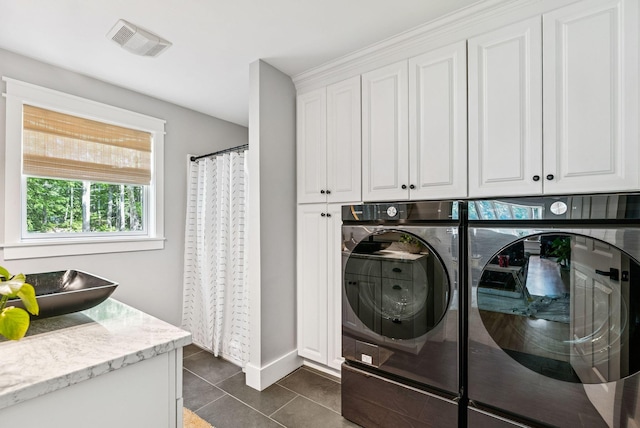 7 Dakota Ln, Dresden, ME 04342 - laundry room featuring cabinet space, washing machine and clothes dryer, and dark tile patterned flooring