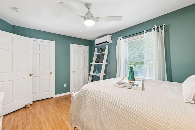 7 Dakota Ln, Dresden, ME 04342 - bedroom featuring an AC wall unit, light wood-type flooring, and a ceiling fan
