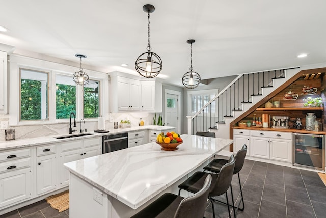 7 Dakota Ln, Dresden, ME 04342 - kitchen with wine cooler, dishwasher, recessed lighting, white cabinetry, and backsplash