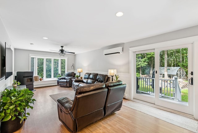7 Dakota Ln, Dresden, ME 04342 - living room with a wall mounted AC, a baseboard radiator, light wood-type flooring, a wainscoted wall, and recessed lighting