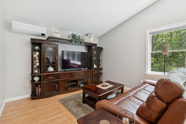 7 Dakota Ln, Dresden, ME 04342 - living room featuring lofted ceiling, light wood-style floors, and a wall mounted AC