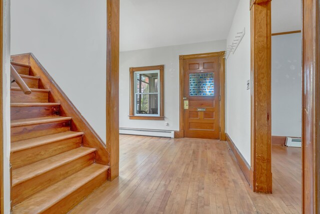 15 Snow Park, Bath, ME 04530 - entrance foyer with a baseboard heating unit, a baseboard radiator, light wood-style flooring, and stairs
