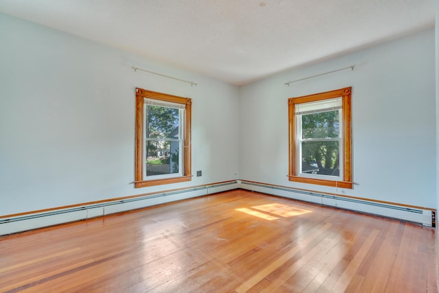 15 Snow Park, Bath, ME 04530 - empty room with healthy amount of natural light, wood-type flooring, and a baseboard radiator