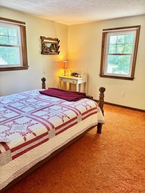 2 Oak Ridge Rd, Kennebunkport, ME 04046 - carpeted bedroom featuring multiple windows and a textured ceiling