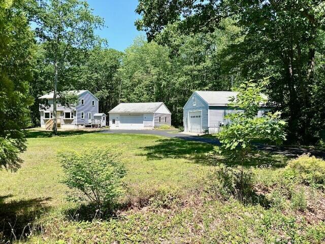 2 Oak Ridge Rd, Kennebunkport, ME 04046 - view of green lawn featuring a garage and an outbuilding