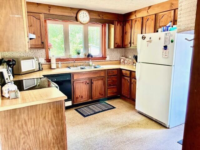2 Oak Ridge Rd, Kennebunkport, ME 04046 - kitchen with white appliances, light countertops, and brown cabinetry