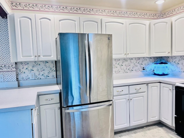 17 Pleasant St, Wilton, ME 04294 - kitchen with freestanding refrigerator, light countertops, white cabinetry, range with electric stovetop, and crown molding