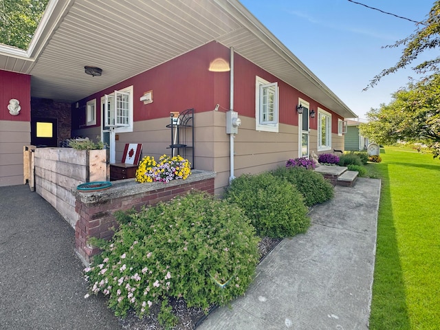 749 Main St, Madawaska, ME 04756 - view of side of property with a yard and an attached carport
