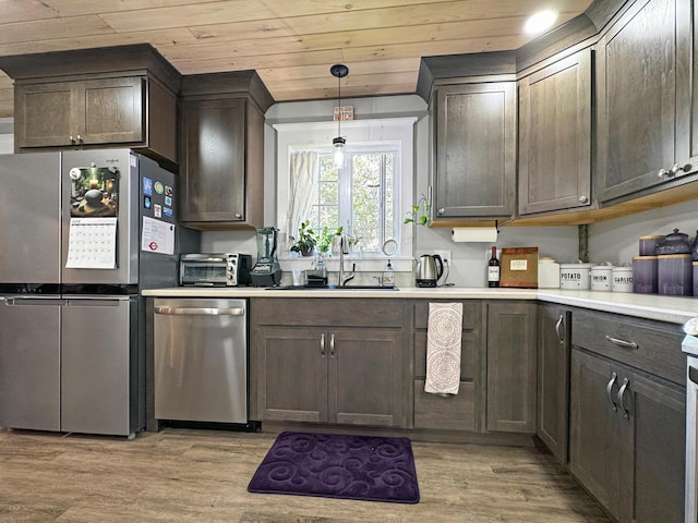 749 Main St, Madawaska, ME 04756 - kitchen featuring appliances with stainless steel finishes, light wood-type flooring, wood ceiling, decorative light fixtures, and light countertops