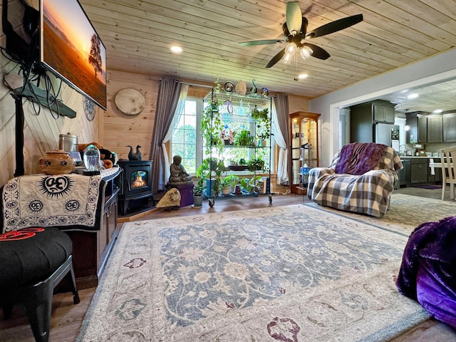 749 Main St, Madawaska, ME 04756 - living room featuring a wood stove, ceiling fan, wood ceiling, and recessed lighting