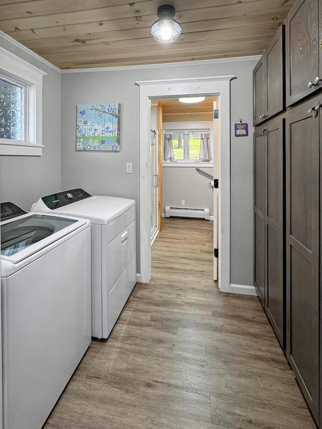 749 Main St, Madawaska, ME 04756 - laundry area featuring cabinet space, separate washer and dryer, a baseboard heating unit, light wood-type flooring, and wooden ceiling