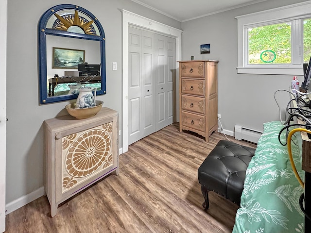 749 Main St, Madawaska, ME 04756 - sitting room with a baseboard heating unit, wood finished floors, and ornamental molding
