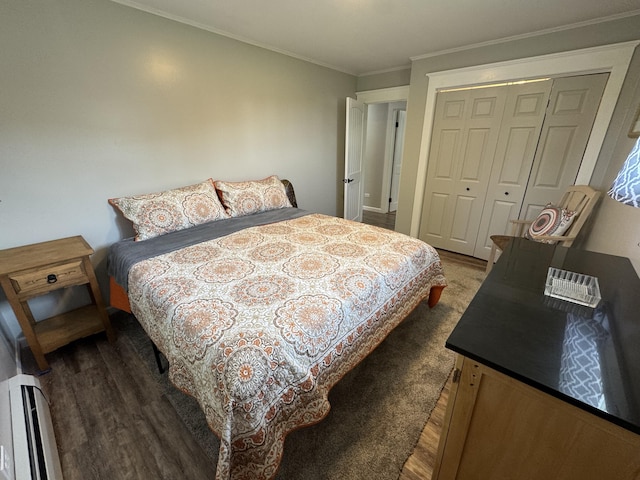 749 Main St, Madawaska, ME 04756 - bedroom with wood finished floors, ornamental molding, a closet, and a baseboard heating unit