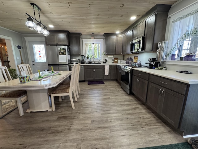 749 Main St, Madawaska, ME 04756 - kitchen with stainless steel appliances, light wood-style floors, wooden ceiling, decorative light fixtures, and light countertops