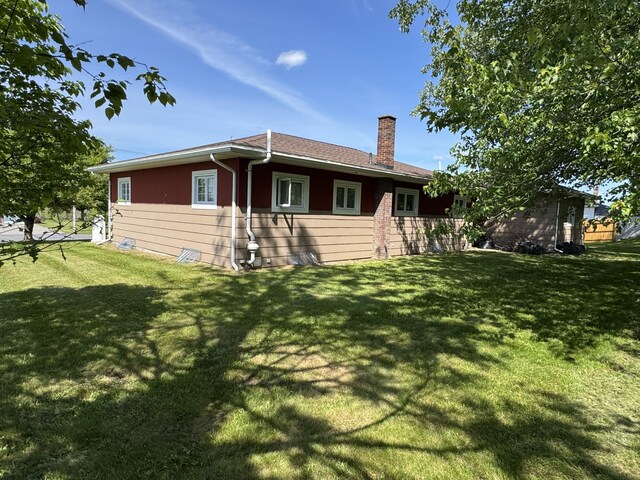 749 Main St, Madawaska, ME 04756 - rear view of house with a chimney and a yard