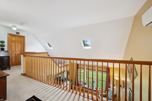 100 Starlight Dr, Brewer, ME 04412 - corridor featuring a skylight, a wall mounted AC, lofted ceiling, carpet floors, and an upstairs landing