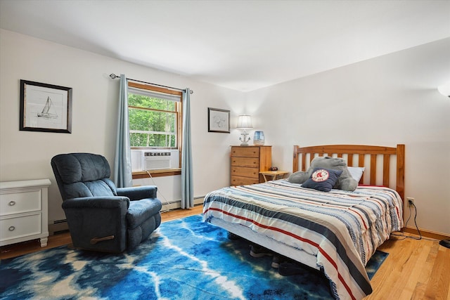 100 Starlight Dr, Brewer, ME 04412 - bedroom featuring cooling unit, wood finished floors, and a baseboard heating unit