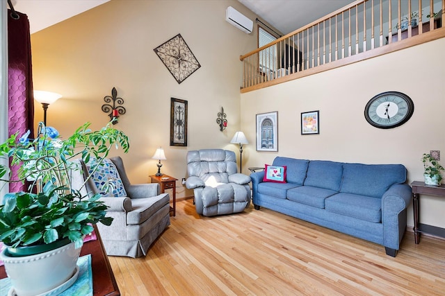 100 Starlight Dr, Brewer, ME 04412 - living room featuring a wall unit AC, wood finished floors, and a high ceiling