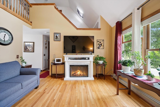 100 Starlight Dr, Brewer, ME 04412 - living area with a baseboard radiator, wood finished floors, a high end fireplace, and vaulted ceiling