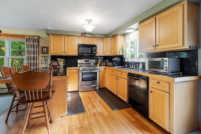 1 Castle View Ln, Belgrade, ME 04917 - kitchen featuring black appliances, plenty of natural light, light brown cabinets, and light wood-style flooring