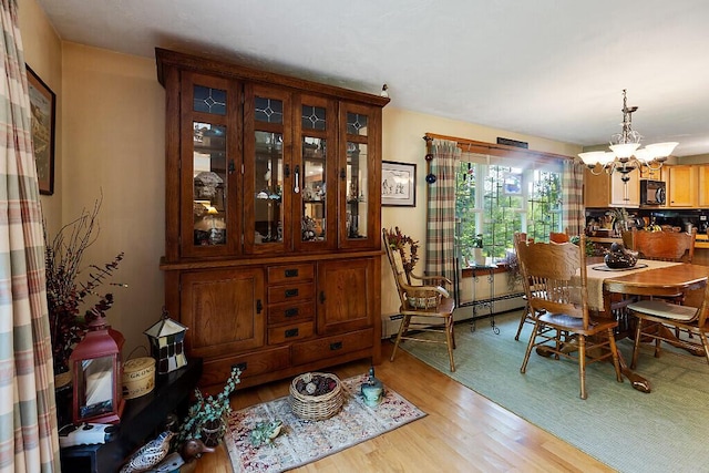 1 Castle View Ln, Belgrade, ME 04917 - dining area with a chandelier, light wood-style flooring, and baseboard heating