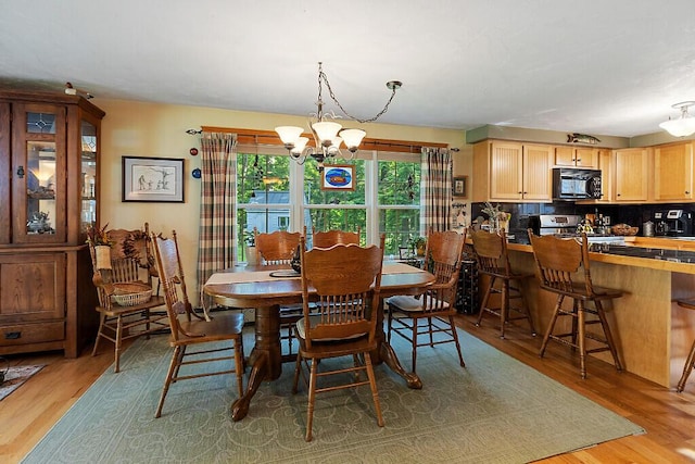 1 Castle View Ln, Belgrade, ME 04917 - dining area with a chandelier and light wood-style flooring