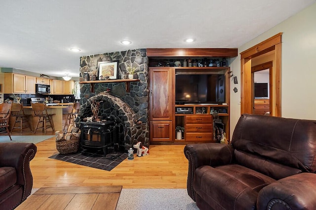 1 Castle View Ln, Belgrade, ME 04917 - living room featuring a wood stove, light wood-style flooring, and recessed lighting