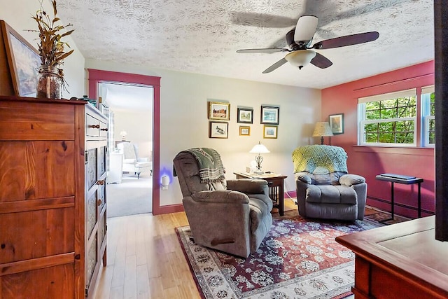 1 Castle View Ln, Belgrade, ME 04917 - living area featuring hardwood / wood-style flooring, ceiling fan, and a textured ceiling