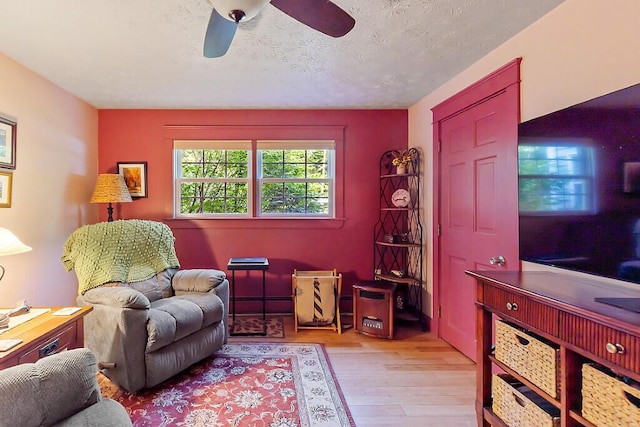 1 Castle View Ln, Belgrade, ME 04917 - sitting room featuring wood finished floors, ceiling fan, and a textured ceiling
