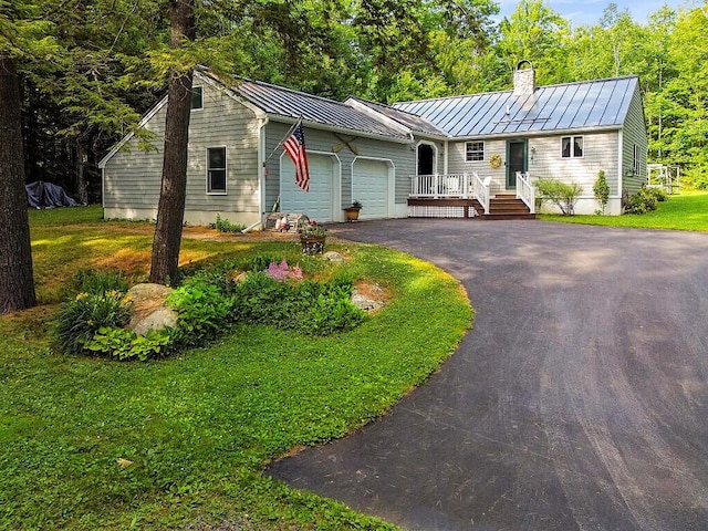 1 Castle View Ln, Belgrade, ME 04917 - single story home featuring a standing seam roof, a chimney, a garage, asphalt driveway, and a metal roof