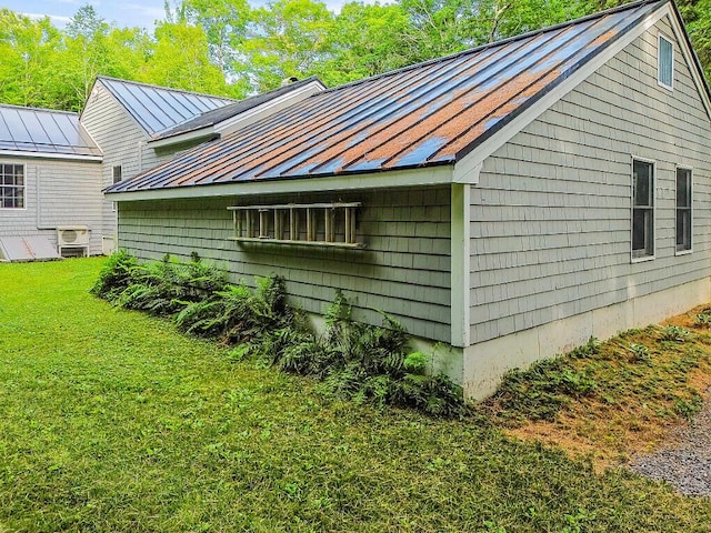 1 Castle View Ln, Belgrade, ME 04917 - view of side of home featuring a standing seam roof, a metal roof, and a lawn