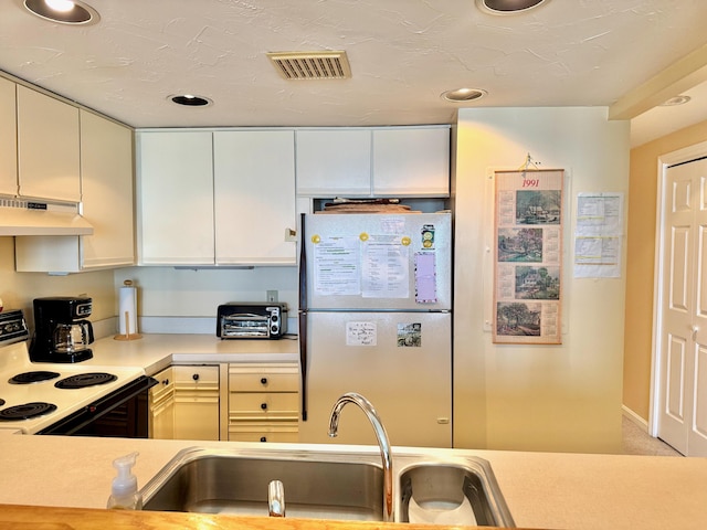 191 E Grand Ave Unit 504, Old Orchard Beach, ME 04064 - kitchen with freestanding refrigerator, under cabinet range hood, white range with electric stovetop, light countertops, and recessed lighting