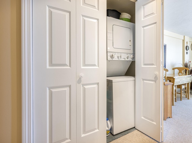 191 E Grand Ave Unit 504, Old Orchard Beach, ME 04064 - laundry area featuring stacked washing machine and dryer and light colored carpet