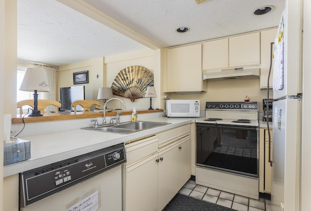 191 E Grand Ave Unit 504, Old Orchard Beach, ME 04064 - kitchen with white appliances, under cabinet range hood, cream cabinetry, light countertops, and light tile patterned flooring