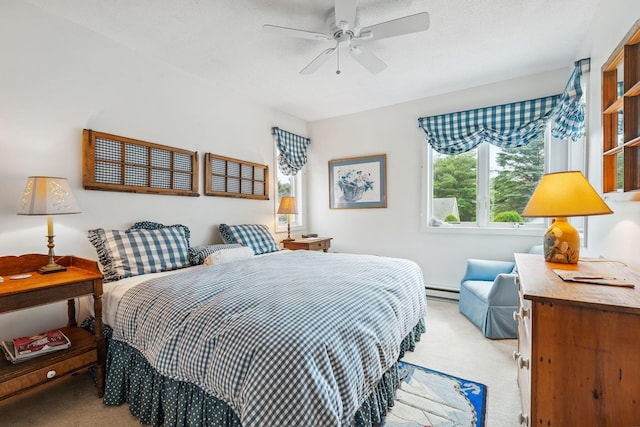 239 Sea Rd Unit 32, Kennebunk, ME 04043 - bedroom with carpet floors, baseboard heating, and a ceiling fan