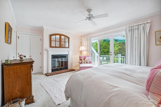 239 Sea Rd Unit 32, Kennebunk, ME 04043 - carpeted bedroom with access to exterior, crown molding, a glass covered fireplace, a textured ceiling, and french doors