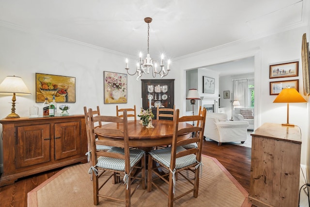 239 Sea Rd Unit 32, Kennebunk, ME 04043 - dining space with dark wood finished floors, crown molding, and a chandelier